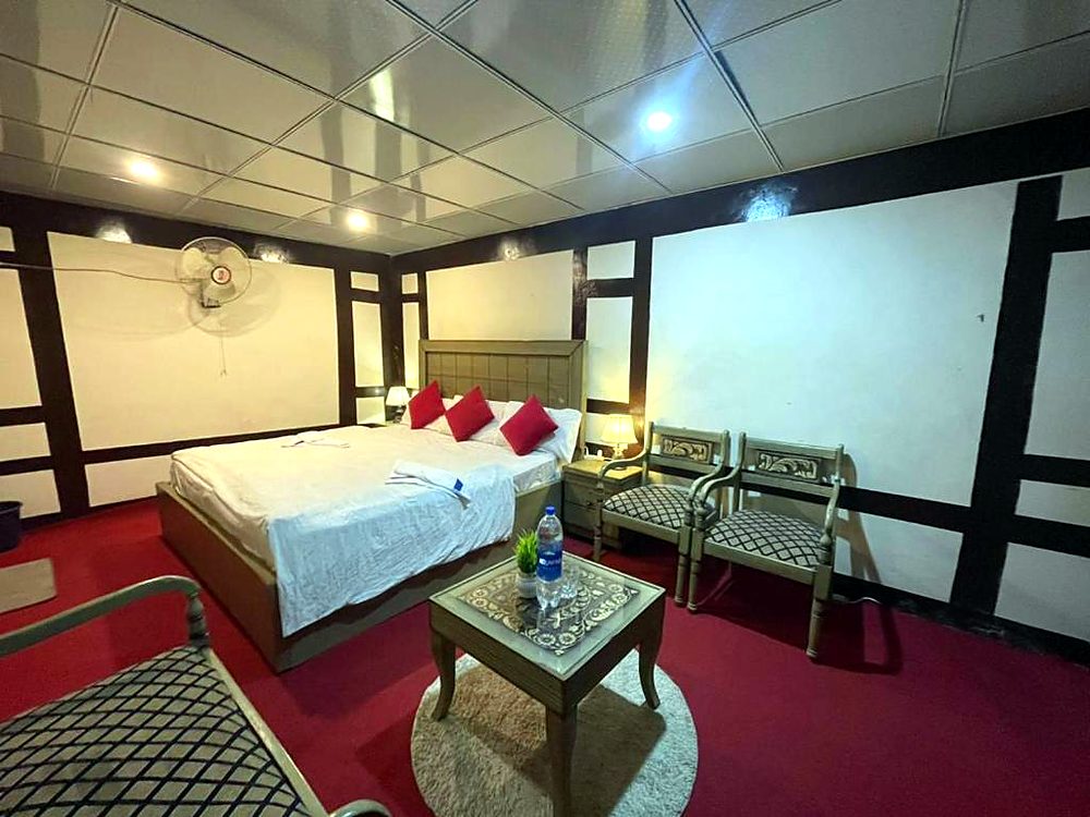 Deluxe Room with queen bed and seating at Ringchan Guest House