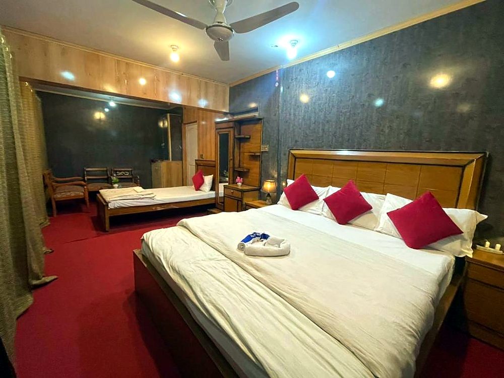Deluxe Family Room with large bed and seating area at Ringchan Guest House